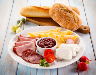 Breakfast - sausages, yellow cheese and vegetables