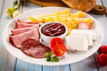 Breakfast - sausages, yellow cheese and vegetables