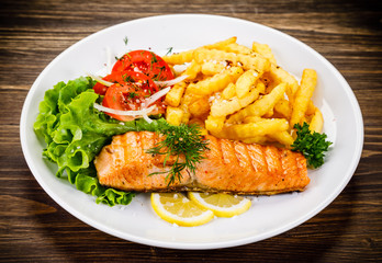 Fried salmon, chips and vegetables