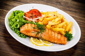 Fried salmon, chips and vegetables