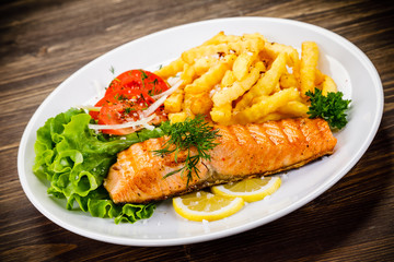 Fried salmon, chips and vegetables