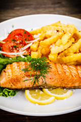 Fried salmon, chips and vegetables