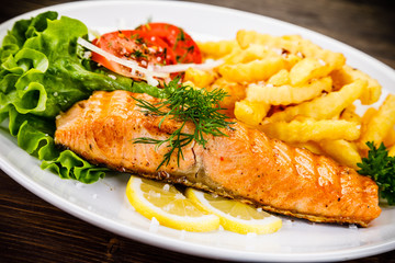 Fried salmon, chips and vegetables