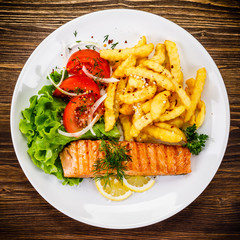 Fried salmon, chips and vegetables