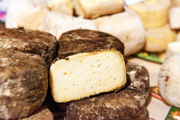 Various types of cheese on wooden desk