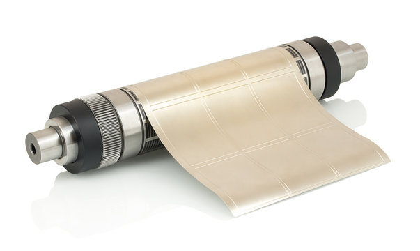 Magnetic cylinder with attached flexible die for die cutting on rotary, flexographic or in-line press printing machine used for label manufacturing isolated on white background with shadow reflection.