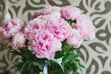 Obraz premium Elegant bouquet of a lot of peonies of pink color close up. Beautiful flower for any holiday. Lots of pretty and romantic flowers in floral shop.