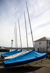 Row of boats in storage under the awning, Warehouse on the boat pier, Plymouth, Devon, United...