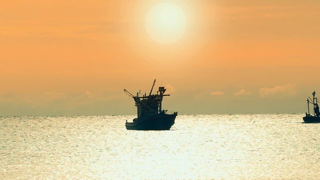 fisherman boat remote from seashore, abstract background exterior view looking toward to the cloudy sky with full of light