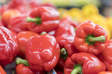 ed pepper on street market shelf. Red bell pepper pattern. Background of fresh sweet heap of red pepper paprica closeup vegetable shop. Red bulgarian paprika harvest pile from organic farm for sale