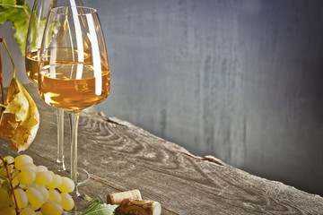 Glass of white wine on vintage wooden table