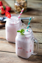 two glasses of fruit yogurt on wooden background
