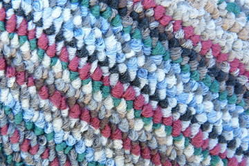 motley colored fabric boucle mohair cloth knitwear carpet close-up woolen thread scarf blue red...