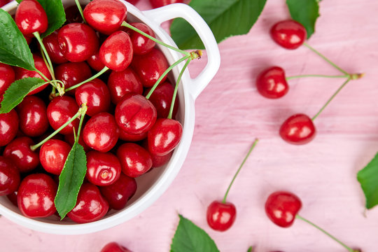 Red cherry in white bowl
