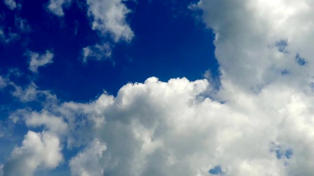 White moving clouds on blue sky background timelapse at summertime. 