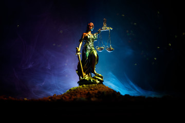 The Statue of Justice - lady justice or Iustitia / Justitia the Roman goddess of Justice on a dark fire background