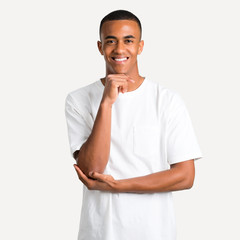 Young african american man smiling and looking to the front with confident face on isolated background