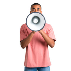 Young african american man shouting through a megaphone to announce something on isolated white background