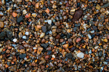 Colorful small stones closeup on beach of of Lake Baikal, Russia.