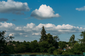 Cumulus clouds over a village in the Black Forest.