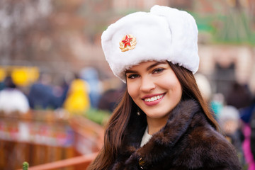 Portrait of a young beautiful girl in a white hat