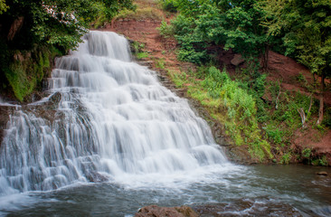Fototapeta premium Dzhurinsky waterfall - a waterfall on the river Dzhurin in Zaleschitsky district of Ternopil region of Ukraine. The height of the waterfall is 16 meters.