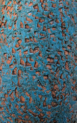 Blue stone wall with orange abstractic dots.       