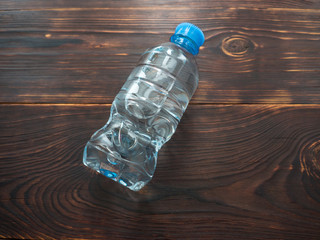 Bottle of clean water on a wooden table