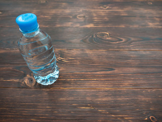 Bottle of clean water on a wooden table