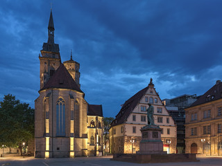 Stuttgart, Germany. Schillerplatz square with Friedrich Schiller memorial and Stiftskirche (Collegiate Church) in dusk. The memorial was erected in 1839.