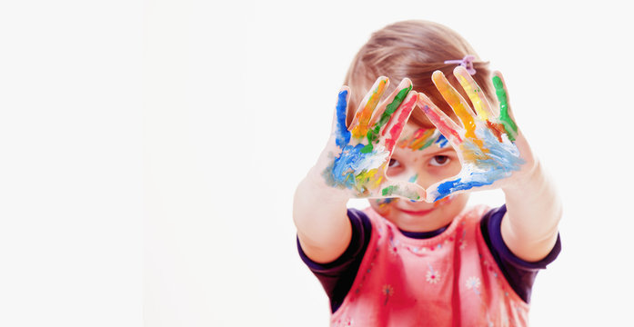 Humorous portrait of little cute girl with children's makeup and painting colorful hands. (people, childhood, art concept)