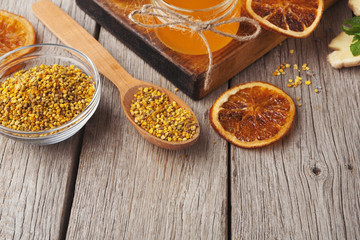Various types of honey on wooden platter, closeup