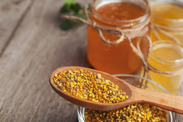 Jar of honey on wooden background