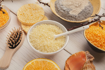 Orange sea salt and face cream on white wood