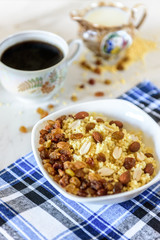 Millet porridge with milk, raisins and peanuts on light background. Healthy breakfast.