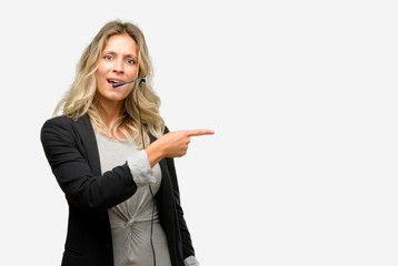 Young woman operator from call center pointing away side with finger