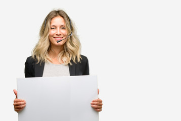 Fototapeta premium Young woman operator from call center holding blank advertising banner, good poster for ad, offer or announcement, big paper billboard