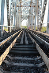 bridge on the railroad tracks and industrial gray stone