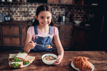 girl eating colorful corn flakes