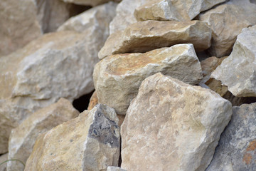 Building material stone. The light stone is straightened in a pile.
