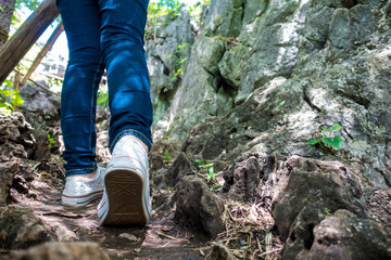 woman's feet walking in nature trail