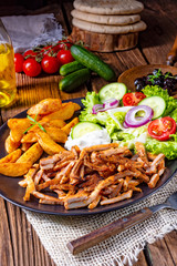 Rustic gyros plate it green salad and potato wedges