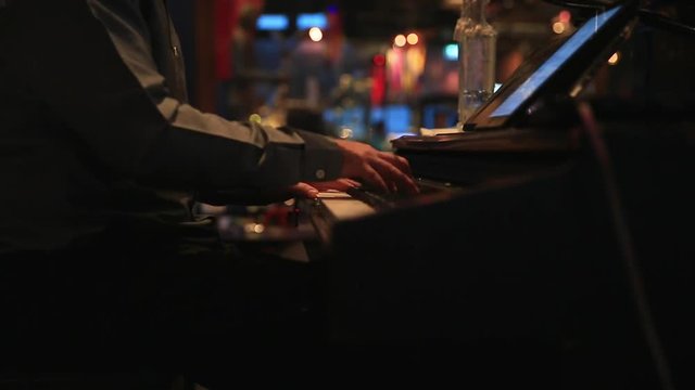 Musician playing piano showing in restaurant