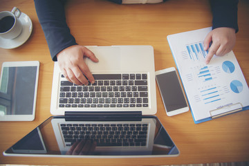 Businessman working with sheet analysis charts.