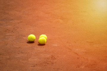 A lonely Tennis Ball on a Sand Court