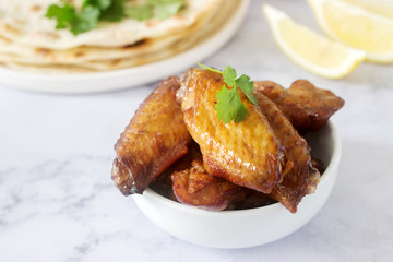 Homemade delicious food of tortillas, salsa and fried wings.