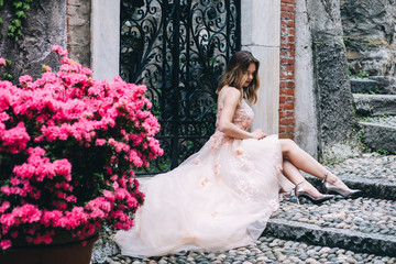 A bride in a white dress is holding a beautiful wedding bouquet.
