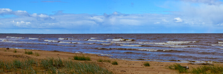 Panoramic seascape, beach with ocean waves, skyline and clouds 