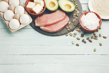 Concept of ketogenic diet. Dietary food on light table