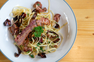 Delicious spaghetti with bacon on wooden table